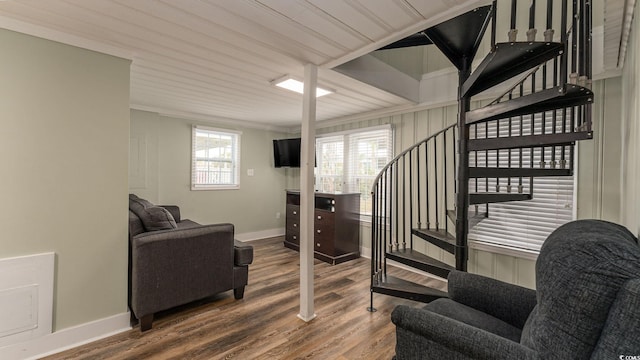 stairs featuring crown molding, baseboards, and wood finished floors