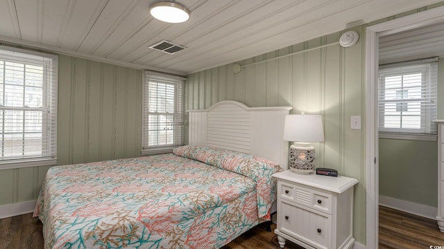 bedroom featuring dark wood-style floors, wooden ceiling, visible vents, and baseboards