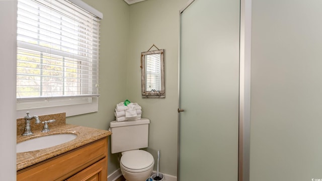 full bathroom with vanity, toilet, and a shower with door