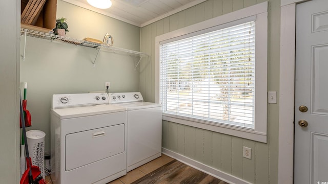 washroom with laundry area, wood walls, light wood-style floors, independent washer and dryer, and crown molding