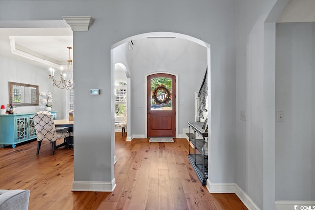 foyer entrance with a notable chandelier and light hardwood / wood-style floors