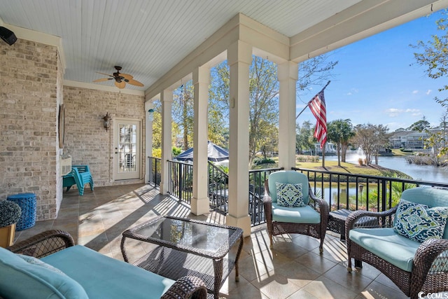 sunroom with a water view, ceiling fan, and wood ceiling