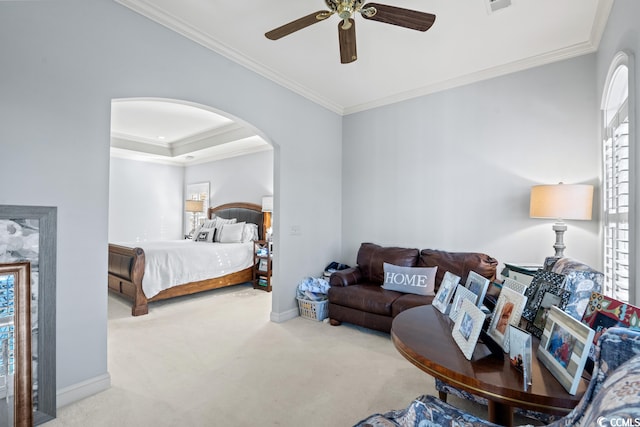 carpeted bedroom featuring ornamental molding, multiple windows, and ceiling fan