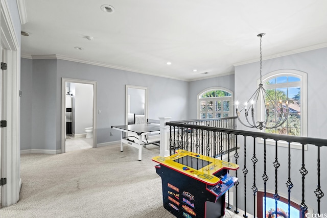 playroom featuring light carpet, ornamental molding, and a notable chandelier