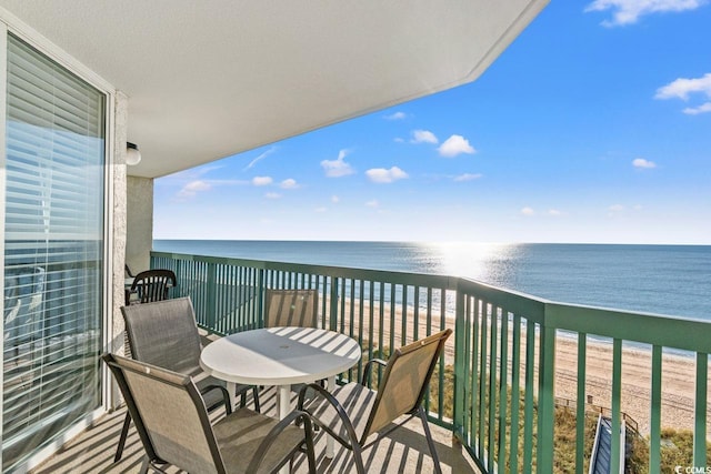 balcony with a water view and a beach view