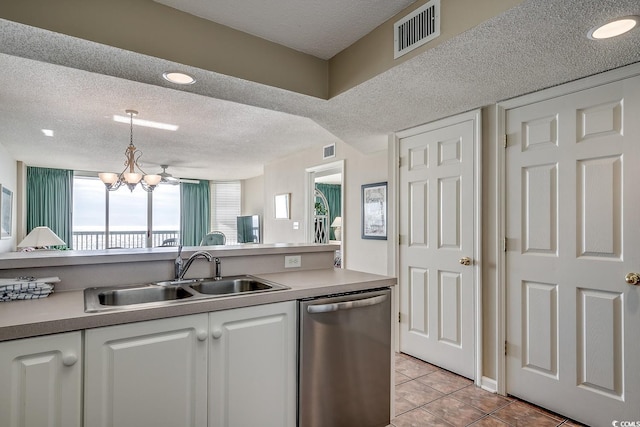 kitchen with dishwasher, sink, hanging light fixtures, a textured ceiling, and white cabinets