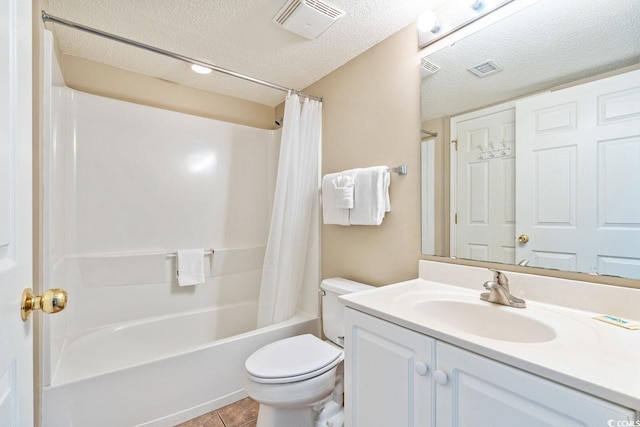 full bathroom with vanity, tile patterned flooring, toilet, a textured ceiling, and shower / tub combo with curtain