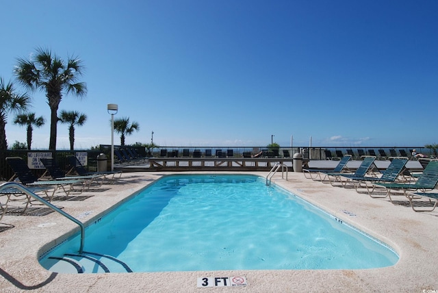 view of swimming pool with a patio