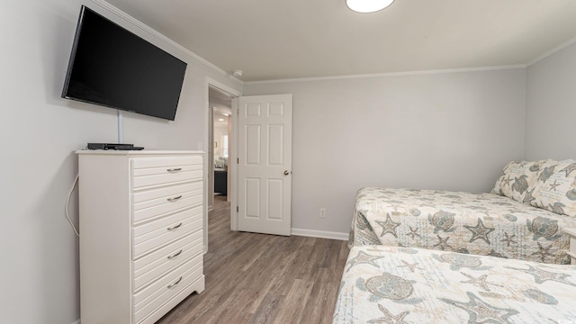 bedroom featuring hardwood / wood-style flooring and ornamental molding