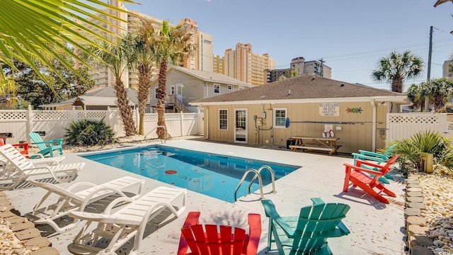 view of pool with a patio area, a fenced backyard, and a fenced in pool