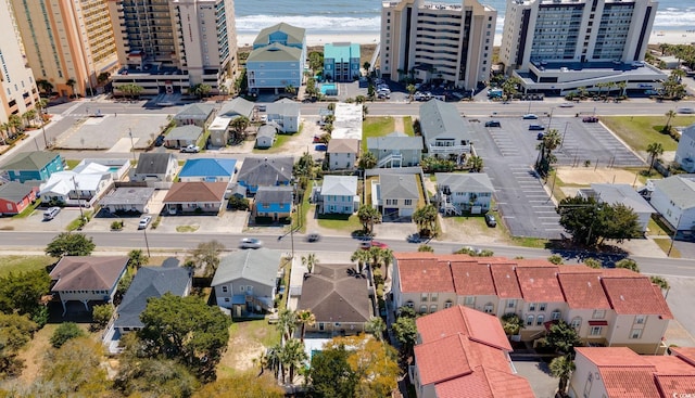 birds eye view of property with a water view and a view of the beach