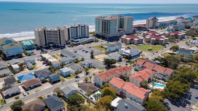 birds eye view of property with a water view and a view of the beach