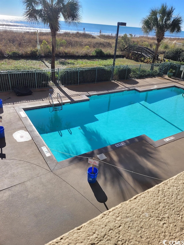 view of swimming pool with a water view