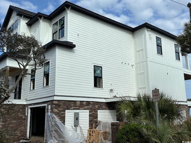 4300 N Ocean Blvd, Myrtle Beach, SC 29577 - back of property with a garage and stone siding
