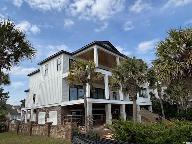 4300 N Ocean Blvd, Myrtle Beach, SC 29577 - back of property with fence, board and batten siding, and a balcony