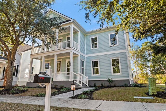 view of front of house with a balcony and covered porch