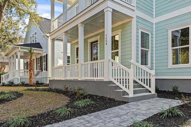 property entrance featuring a shingled roof and a porch