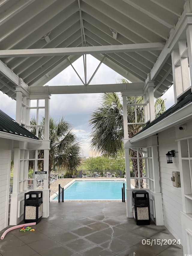 view of swimming pool featuring a fenced in pool, a patio, and a gazebo