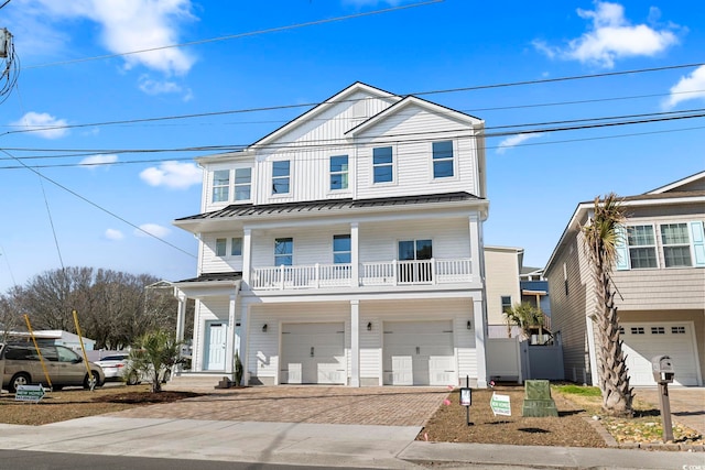 view of front facade featuring a garage and a balcony