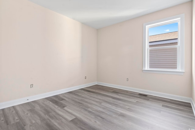 unfurnished room with light wood-type flooring