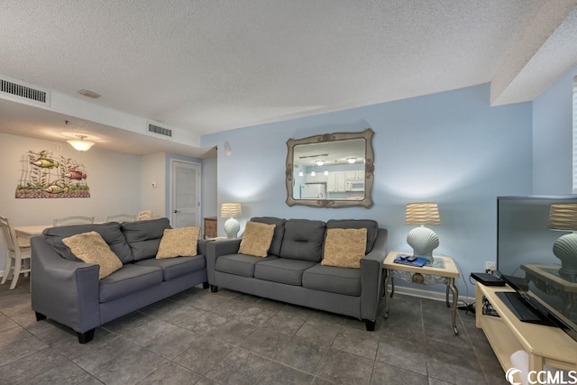 living room featuring visible vents and a textured ceiling