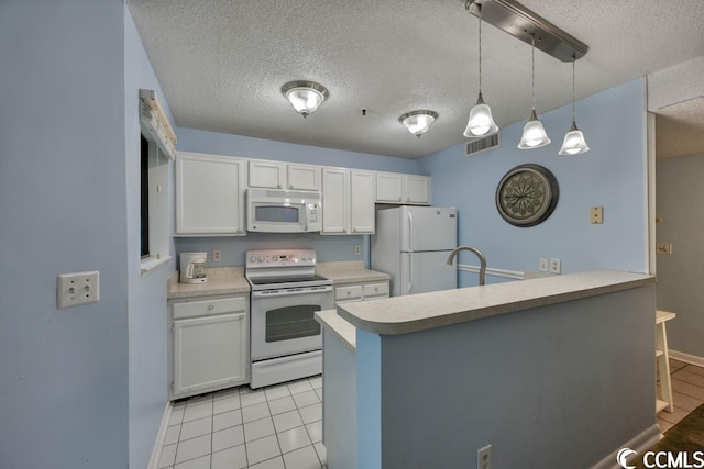 kitchen with pendant lighting, light countertops, white cabinets, white appliances, and a peninsula