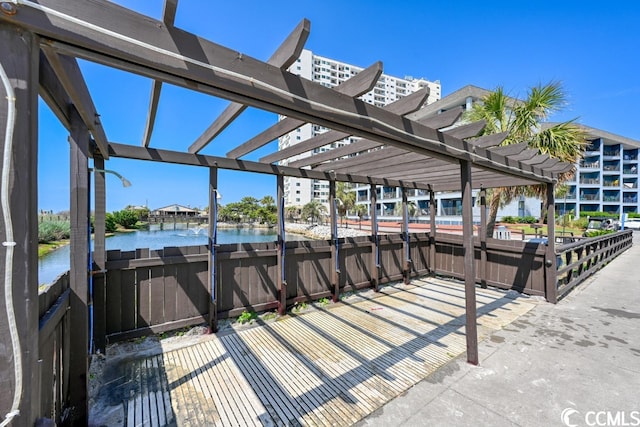 exterior space with a water view and a pergola