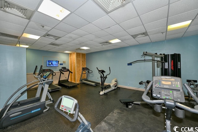 gym with a paneled ceiling, visible vents, and baseboards