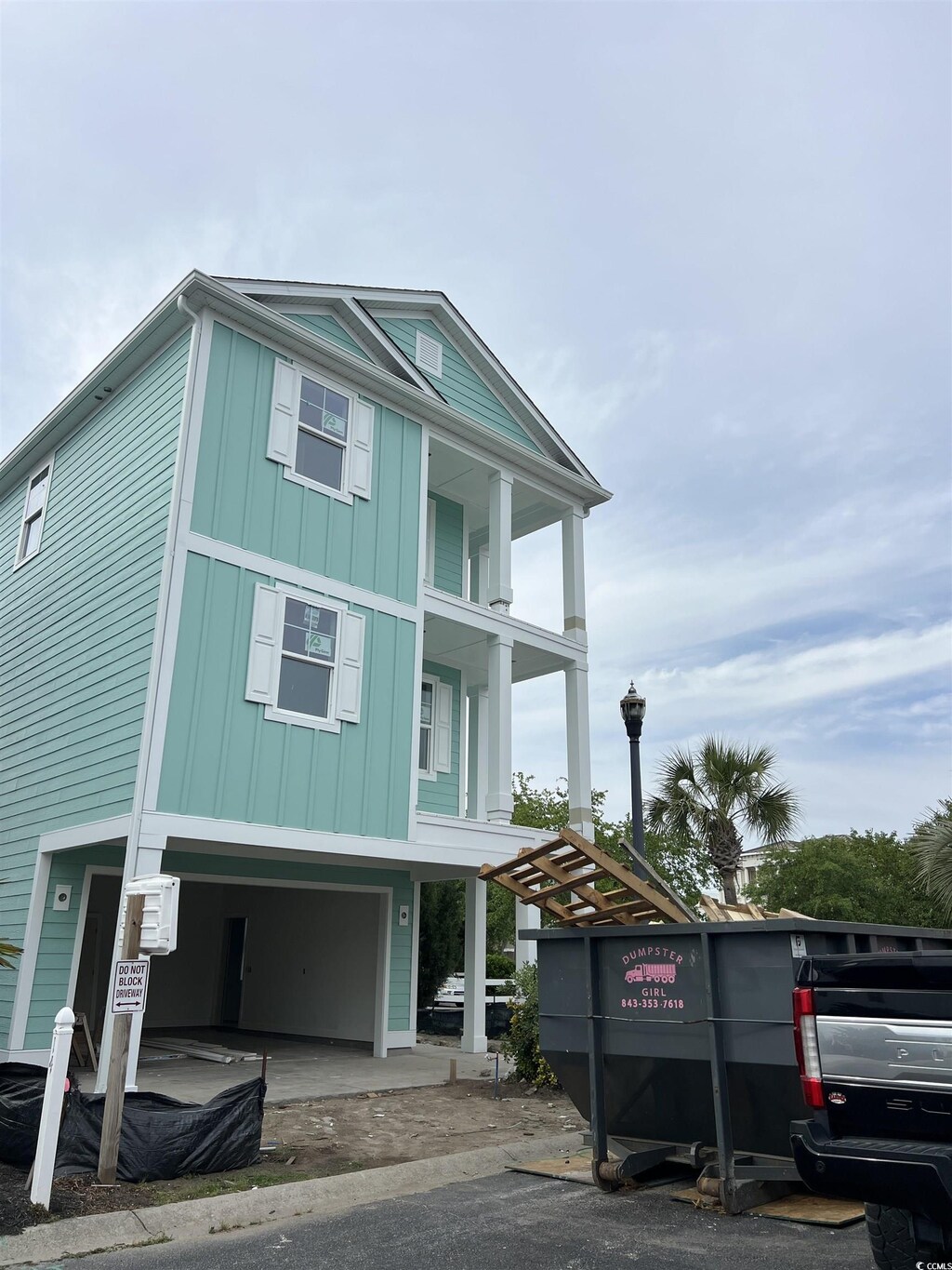 coastal home featuring a garage and board and batten siding
