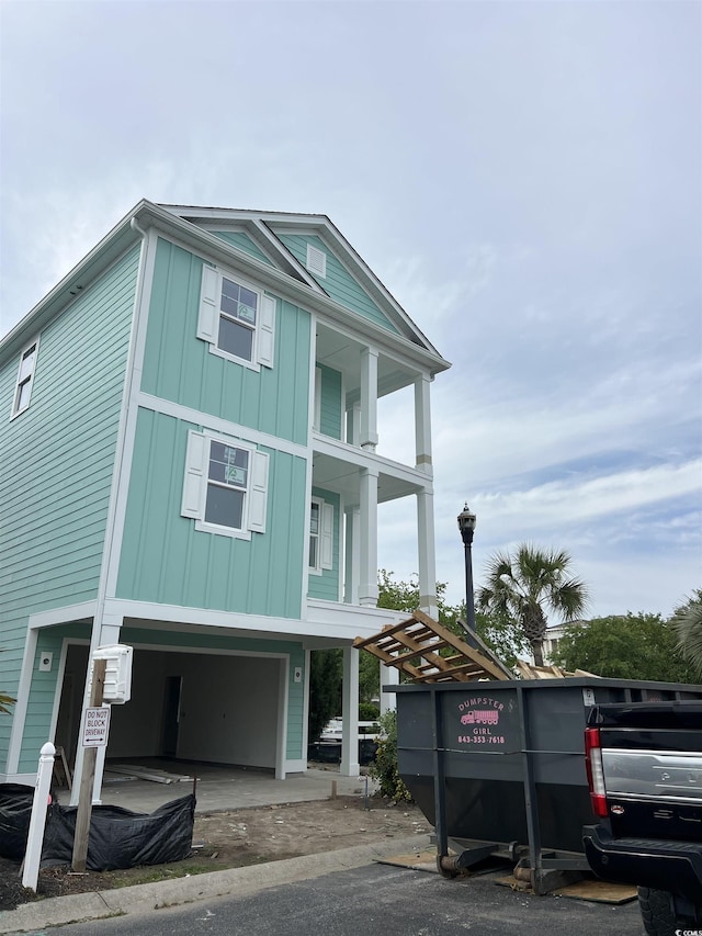 coastal home featuring a garage and board and batten siding