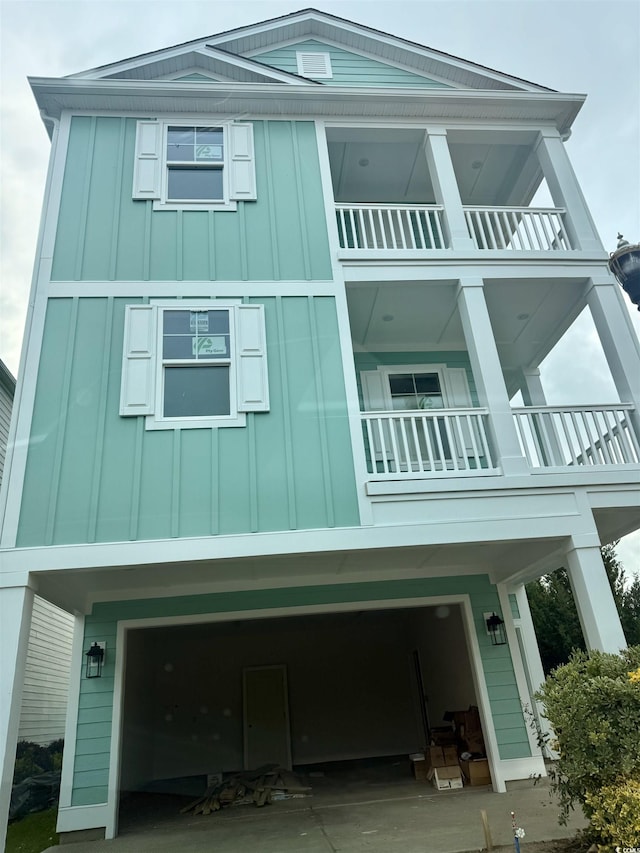 1207 Salt Windy Way N, Myrtle Beach, SC 29582 - view of side of property with a balcony, board and batten siding, and an attached garage