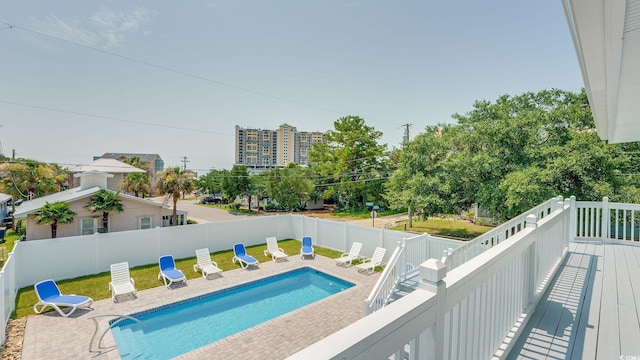 view of swimming pool featuring a fenced in pool, a fenced backyard, and a deck