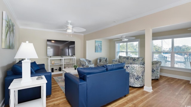 living room featuring ornamental molding, light wood-style flooring, and baseboards