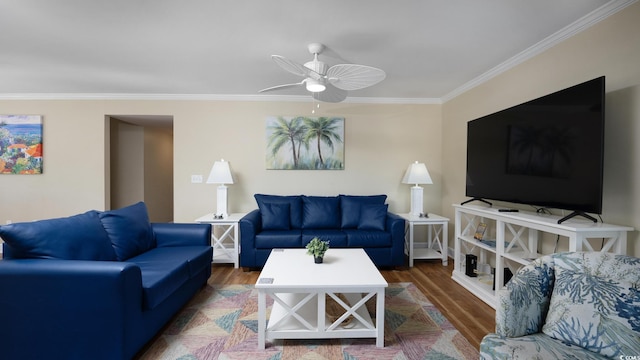 living area featuring ornamental molding, a ceiling fan, and wood finished floors