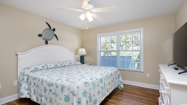 bedroom featuring ceiling fan, baseboards, and dark wood finished floors