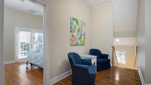 sitting room with baseboards, visible vents, and hardwood / wood-style floors