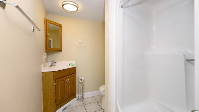 bathroom featuring walk in shower, vanity, toilet, and tile patterned floors