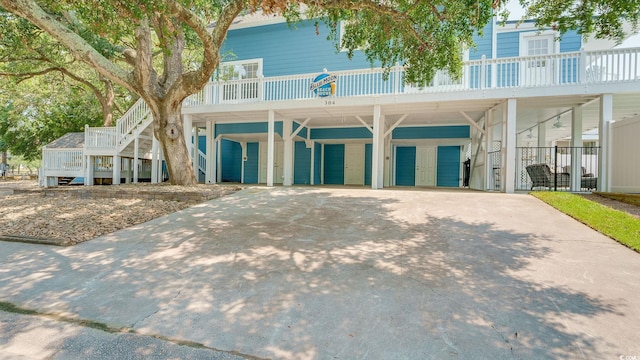 beach home featuring an attached garage and concrete driveway