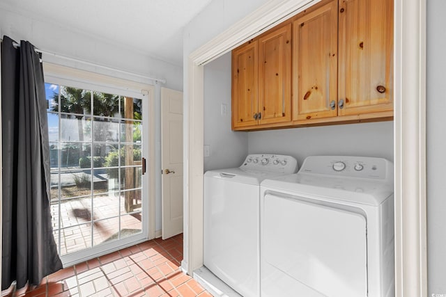 laundry area with independent washer and dryer, light tile floors, and cabinets