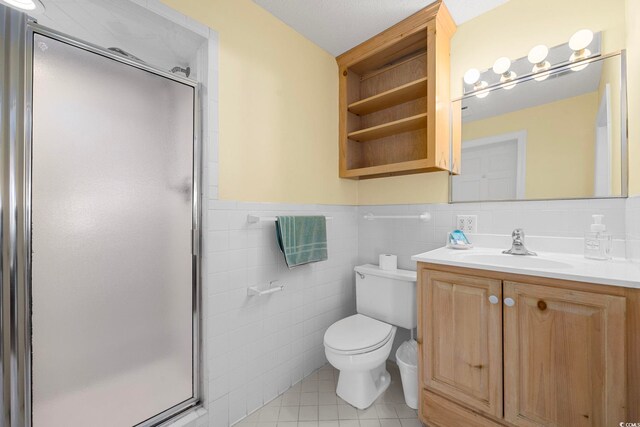 bathroom with tasteful backsplash, toilet, vanity, tile walls, and tile floors