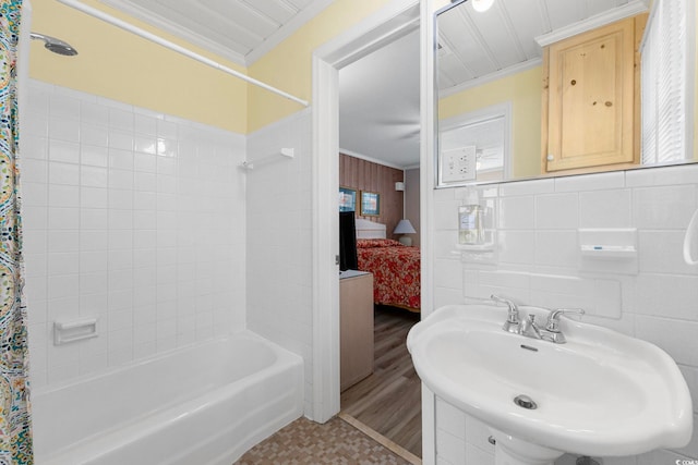 bathroom featuring crown molding, tile walls, and shower / tub combo