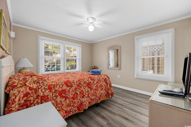 bedroom featuring ceiling fan, ornamental molding, and hardwood / wood-style floors