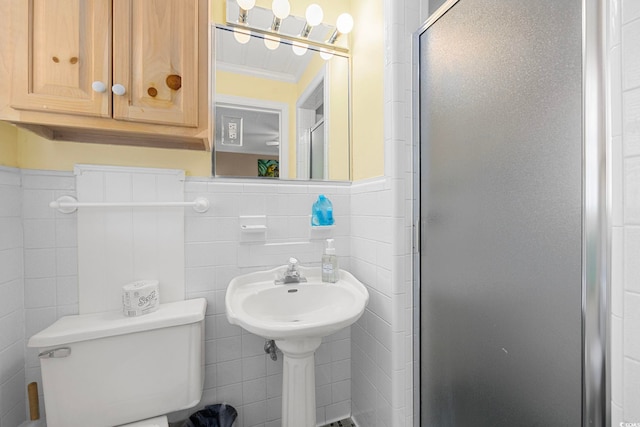 bathroom with tile walls, walk in shower, toilet, ornamental molding, and backsplash