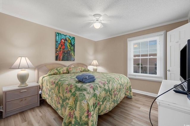 bedroom featuring a textured ceiling, ceiling fan, light wood-type flooring, and crown molding