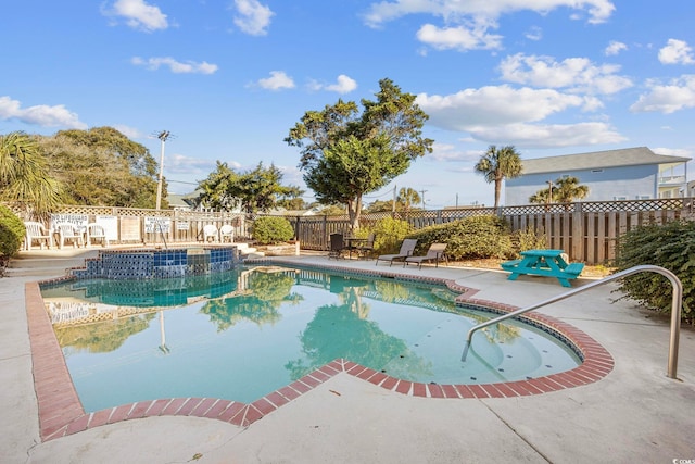 view of swimming pool with a patio area