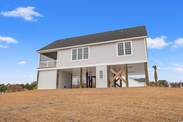 view of front of home featuring stairs, a carport, and roof with shingles