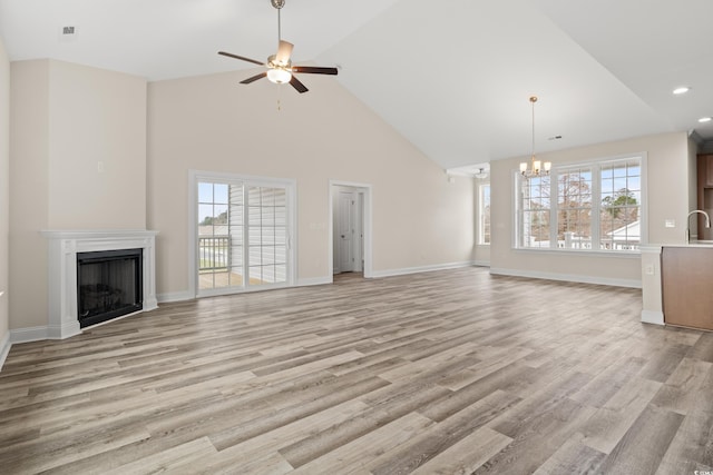 unfurnished living room with light wood-type flooring, a fireplace, and a wealth of natural light