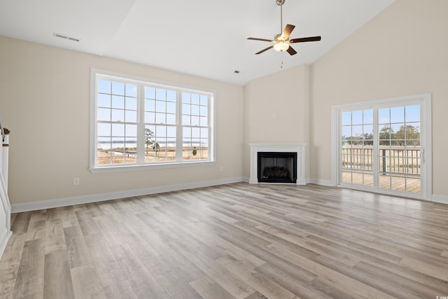 unfurnished living room with light wood-style flooring, a fireplace, visible vents, and baseboards