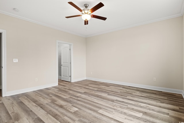 unfurnished room with baseboards, wood finished floors, and crown molding