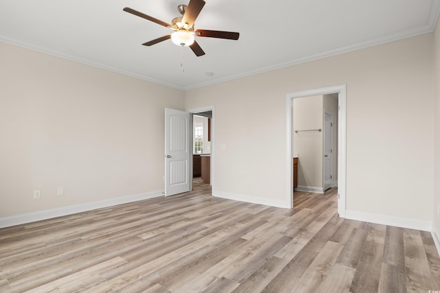 unfurnished bedroom featuring ornamental molding, light wood-style flooring, and baseboards